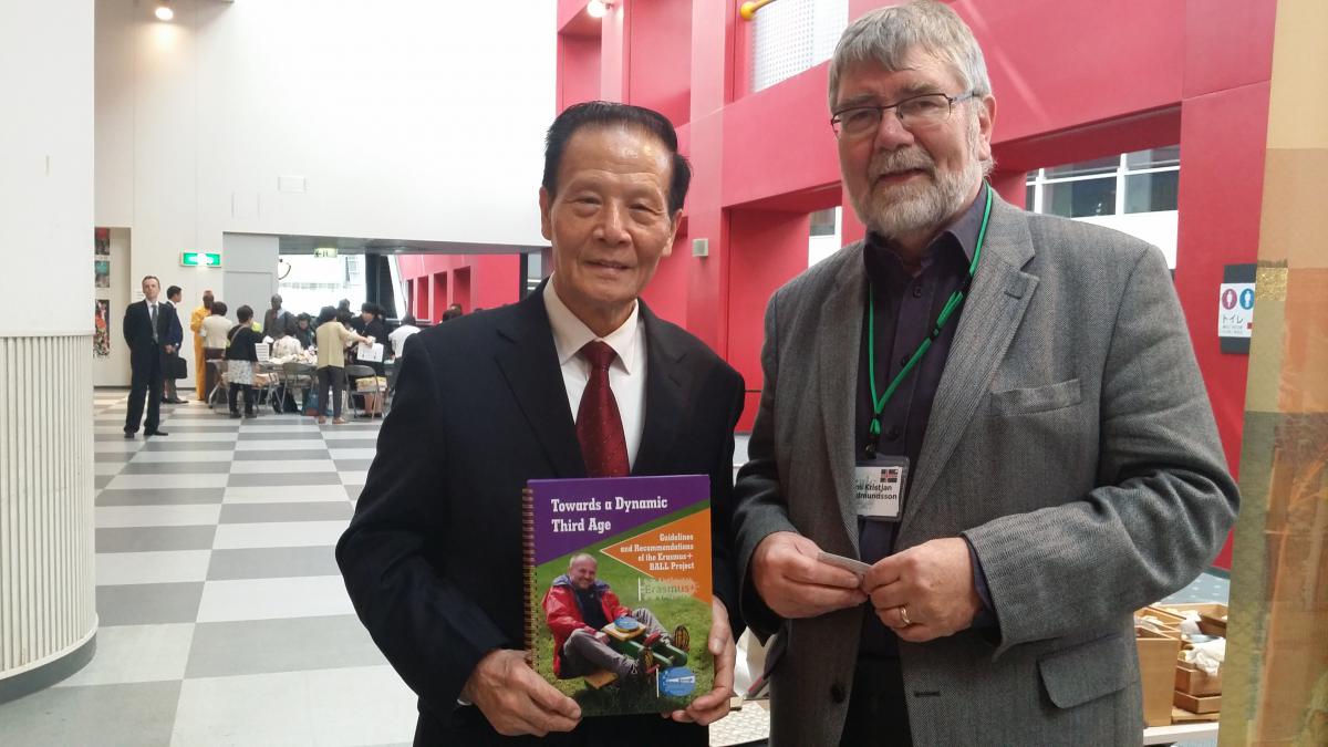 Mr Qicun Yang, president of the Jingdezhen third age university in China receiving a hard copy of the BALL recommendations